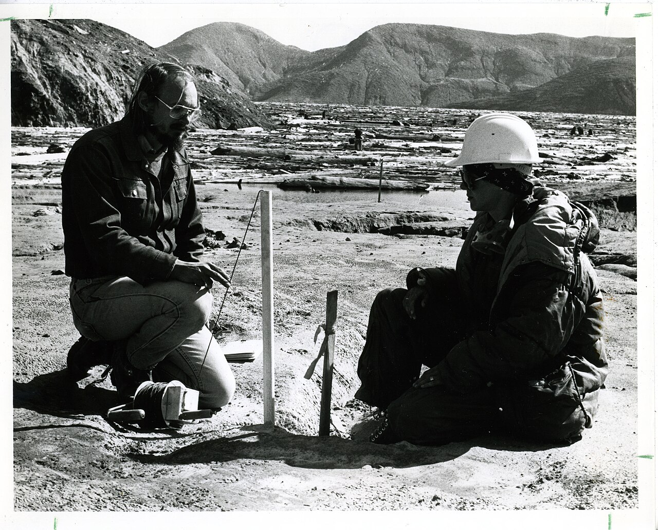 Geologists inspecting and logging drill cores in the field
